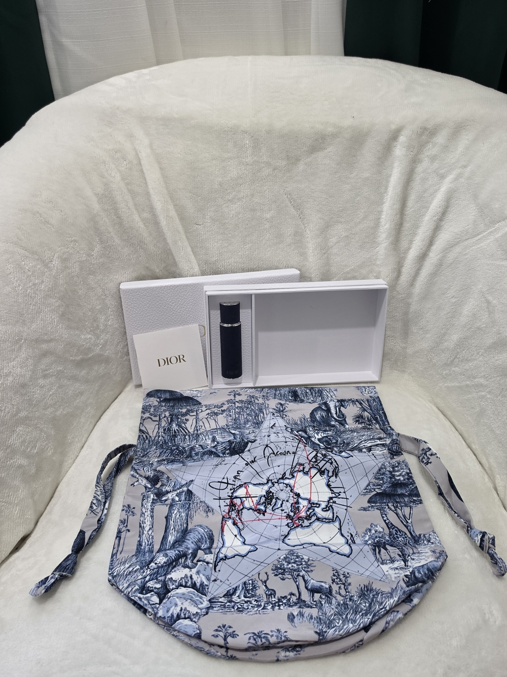Dior Men’s Blue Toile Drawstring Bag & Refillable travel perfume bottle.